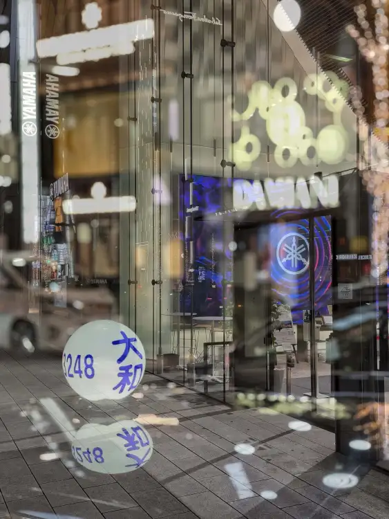 Night mood from the Ginza district in Tokyo, Japan. Digital composite of two individual photos.