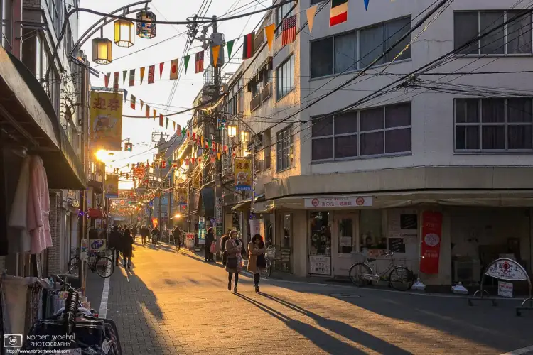 A fine late-afternoon mood created by the setting sun along Higashi-Jujo Shopping Street in Tokyo, Japan.