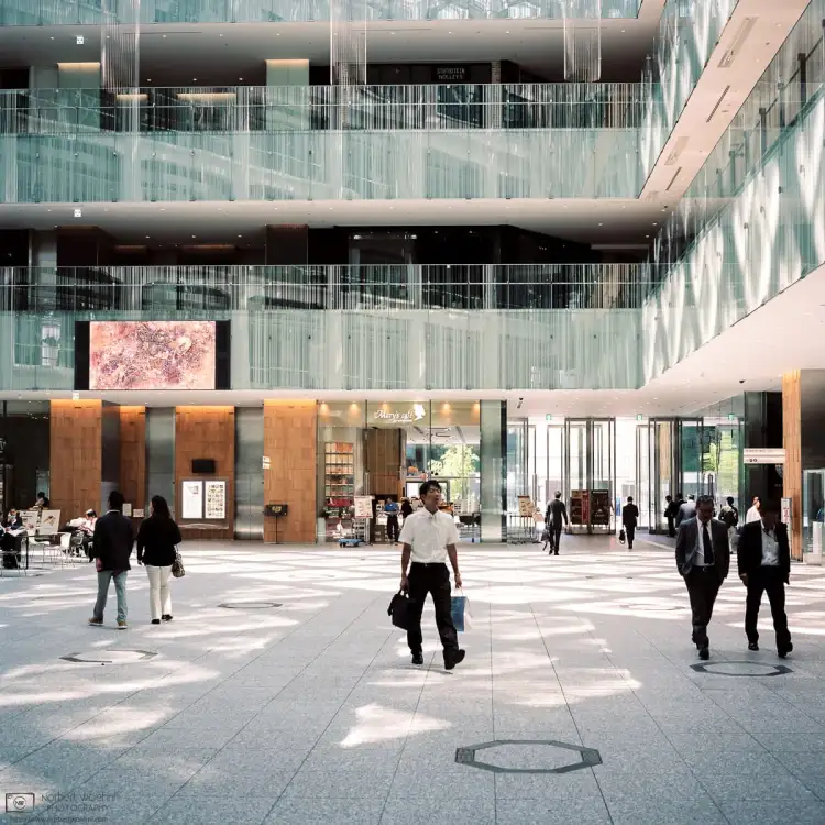 People striding across the Lobby of JP Tower in Tokyo, Japan. From the first roll of film I ever shot on my Mamiya 6 in May 2015.