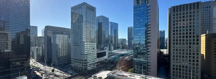 From the 18th floor of an office building in the Marunouchi area of Tokyo, Japan, this is a view towards Tokyo Station and surrounding high-rise buildings.