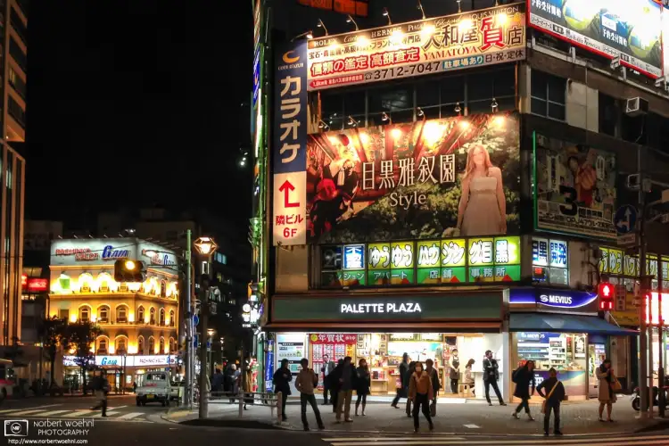 An evening impression taken outside Meguro Station in Tokyo, Japan, at the eastern end of Meguro Dori.