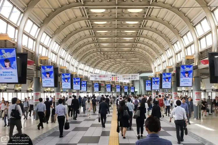 Going with the light mid-day flow of people in the concourse of Shinagawa Station in Tokyo, Japan.