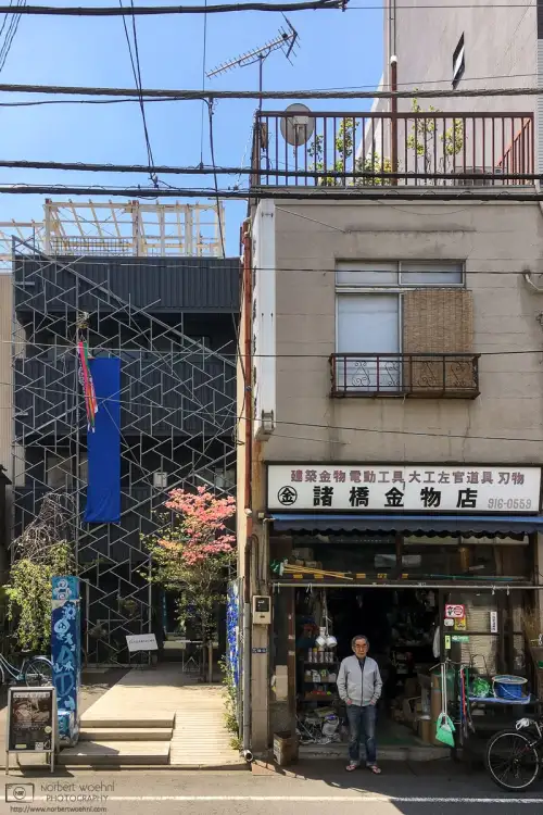 A shop owner is eyeing a foreign photographer in the Takinogawa area of Kita Ward in Tokyo, Japan.