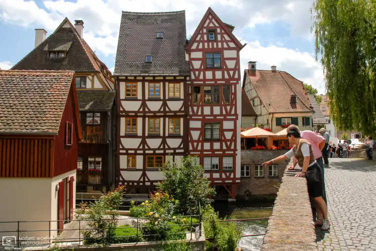 Visitors enjoying the view from Häuslesbruck in the historic Fisherman’s Quarter of Ulm, Germany.