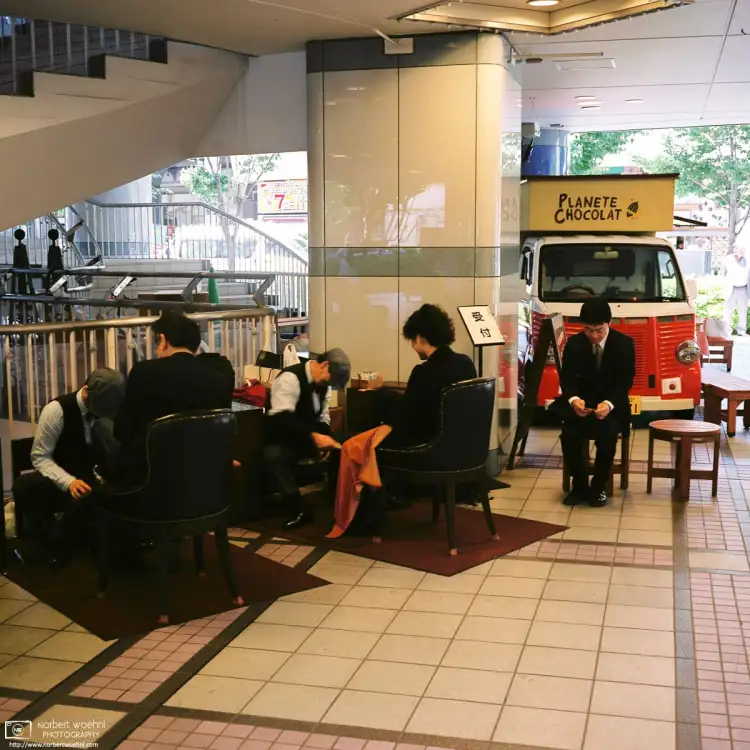 Shoe Shiners working outside Yūrakuchō Station in Tokyo, Japan.
