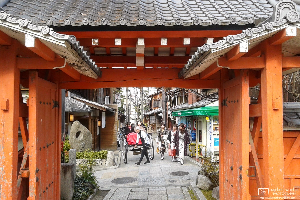Rickshaw and kimono through the Gate of Koshindo Temple, Kyoto, Japan
