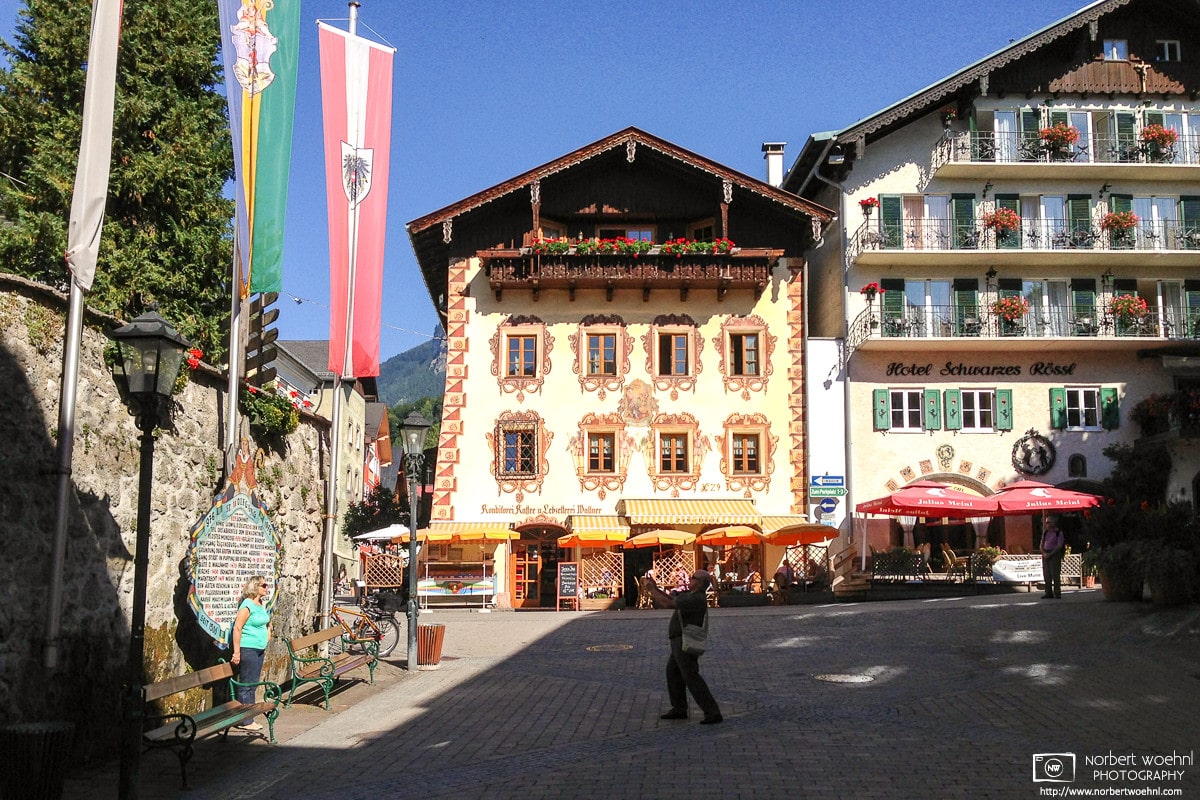 Visitors capturing memories in the beautiful historic town center of Sankt Wolfgang, Austria.